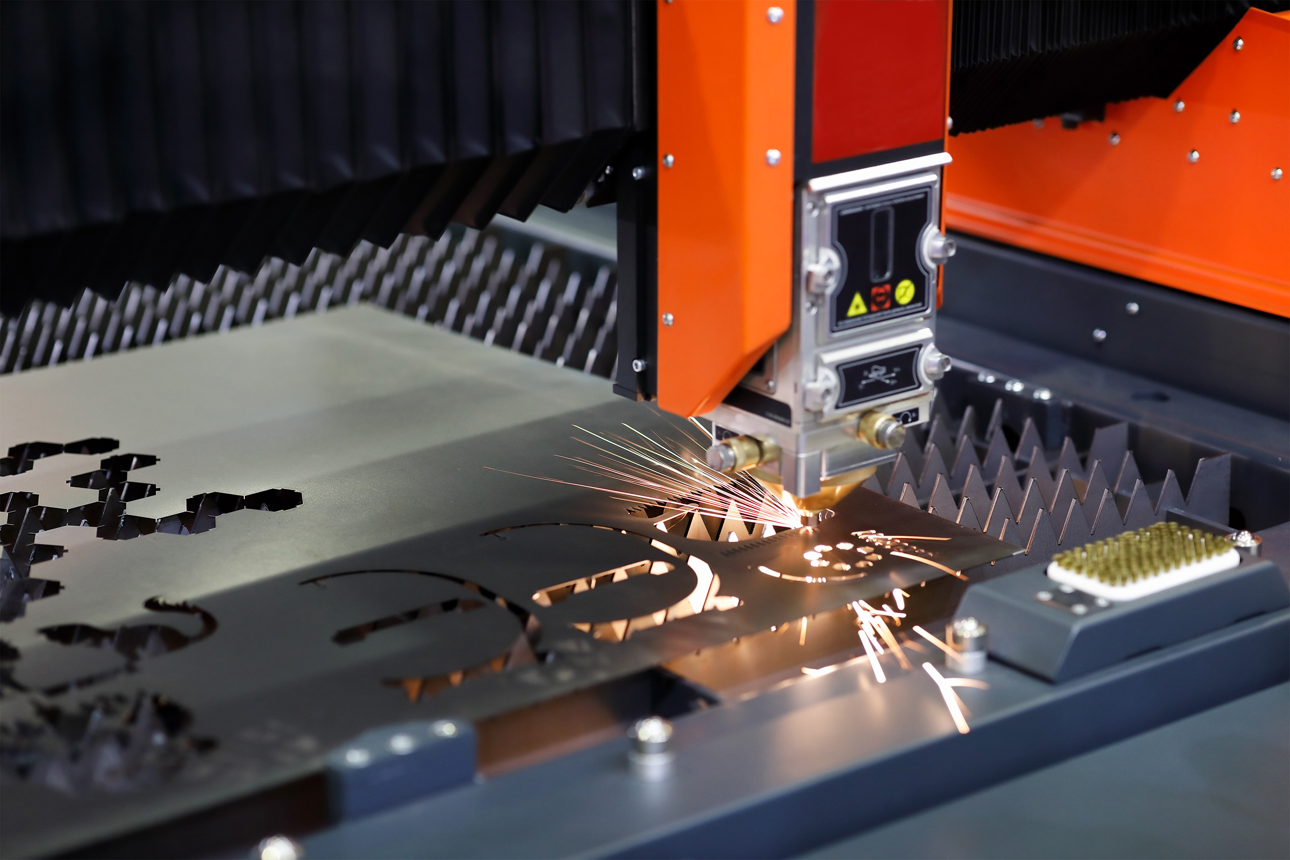 High-powered fiber laser cutting steel for custom metal fabrication