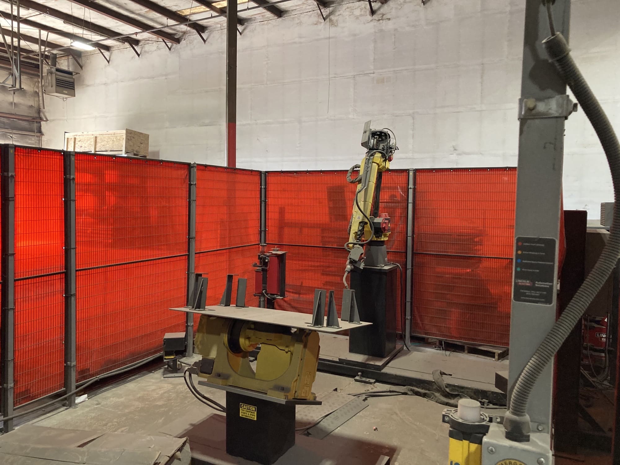 Robotic welding cell performing automated welding on metal components