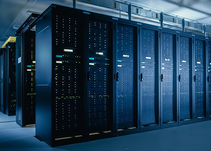 Row of enterprise data center server racks and cabinets in climate-controlled facility.